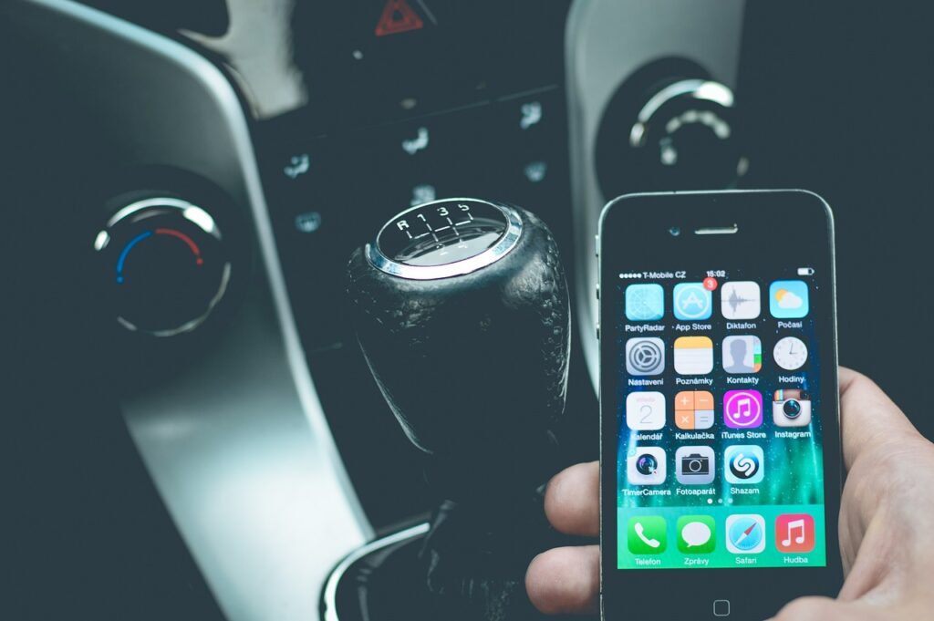 Phone held in hand inside automobile